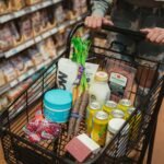 a person pushing a shopping cart full of food